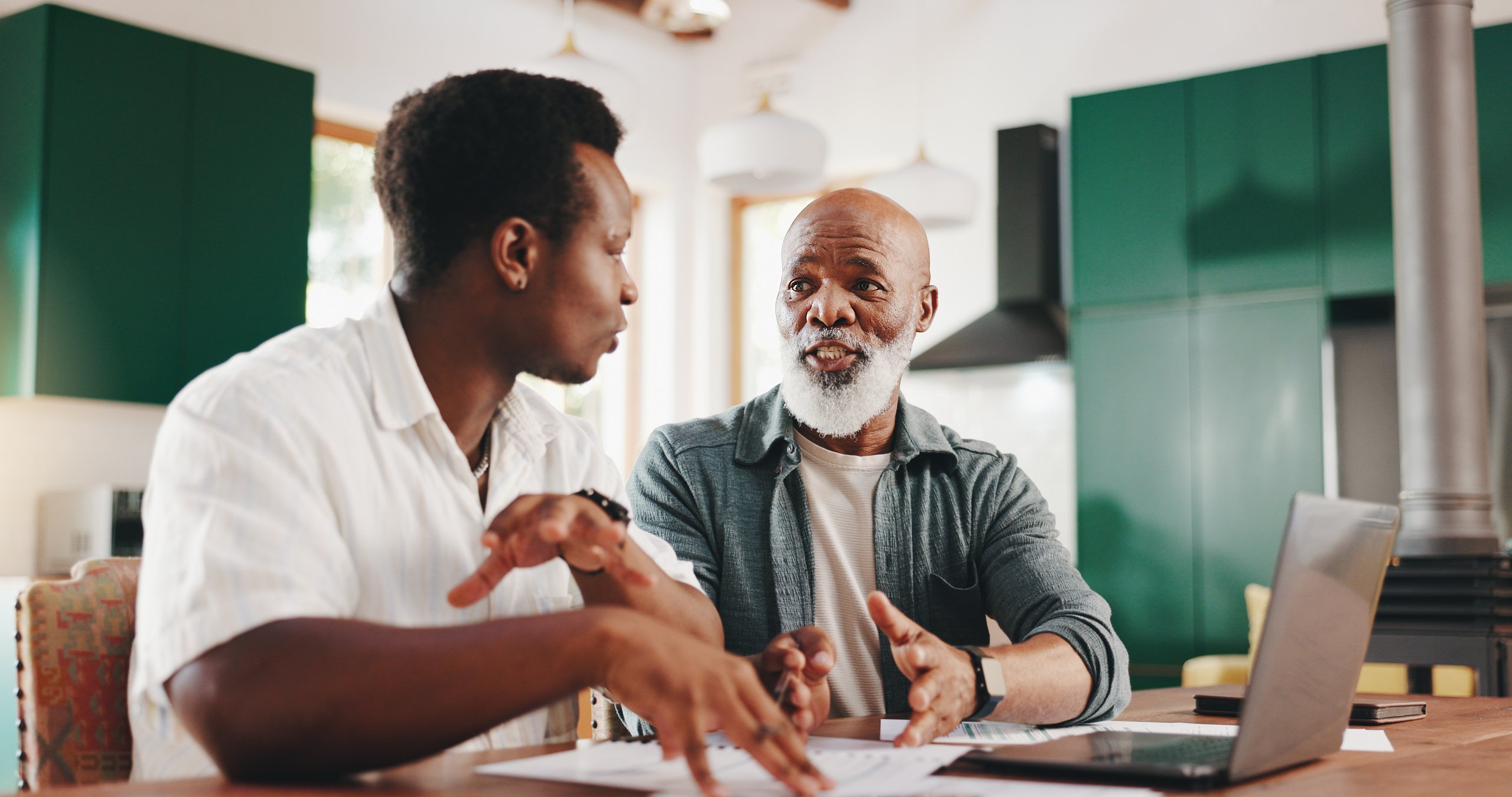 Father and son discussing finances together at home