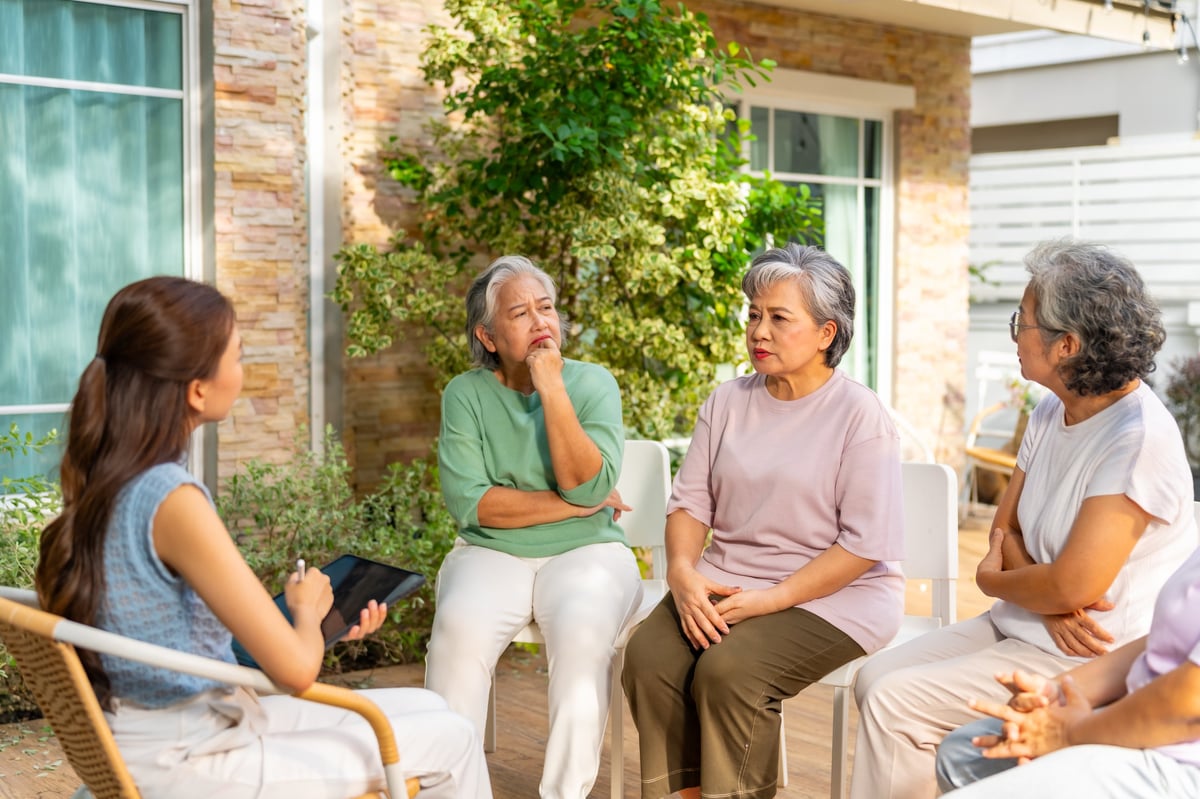 Adult siblings having a calm family conversation about caregiving