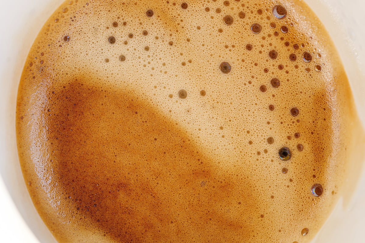 Macro of coffee crema caramel tones create an abstract background
