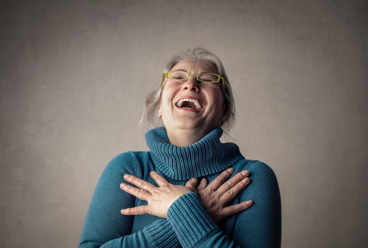 An elderly woman laughing heartily, a candid portrait of joy
